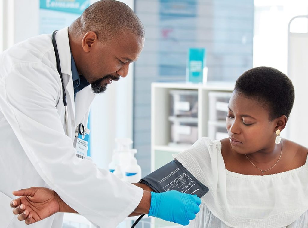 A doctor prepares to measure a patient's blood pressure.